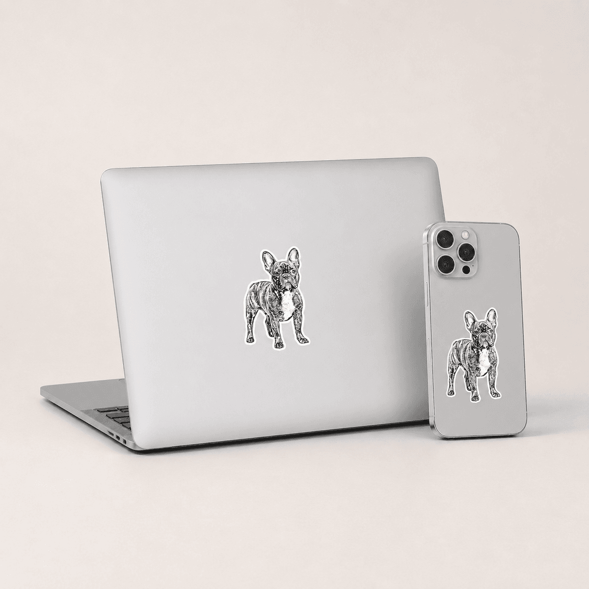 MacBook and iPhone with Woofyful sketch stickers